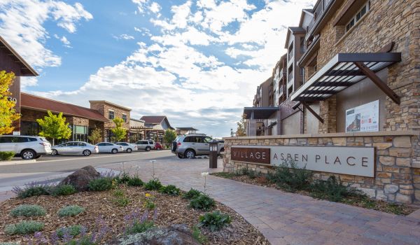 The Village at Aspen Place front sign and parking