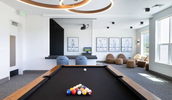 The Grandeur at Holladay Hills game room with pool table and golf simulator