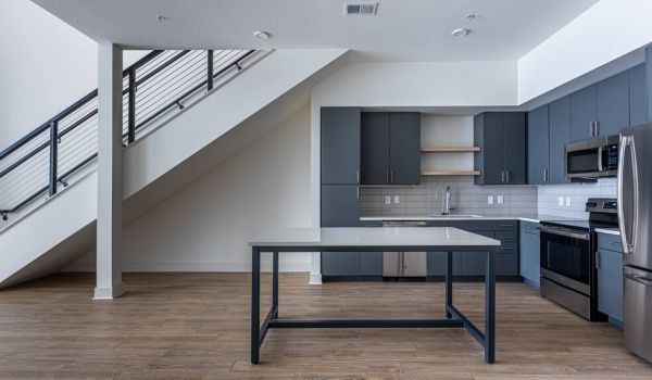 225 Sycamore apartment kitchen and living area with staircase