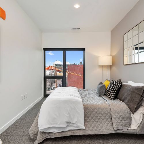 Arterra apartment interior featuring bedroom with large windows