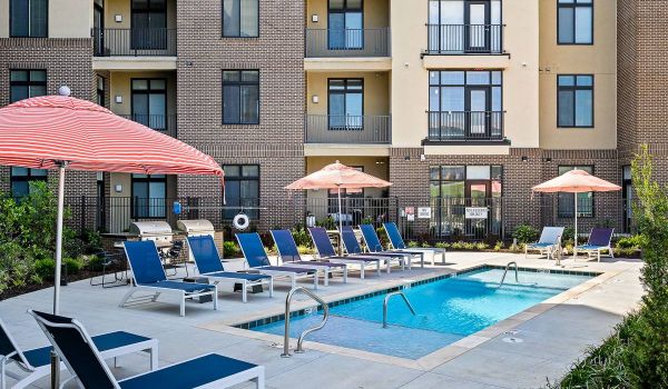 The District Flats apartment community pool and outdoor lounge