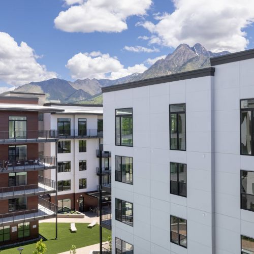 The Grandeur at Holladay Hills building exterior with mountains in background