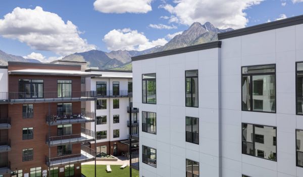 The Grandeur at Holladay Hills building exterior with mountains in background