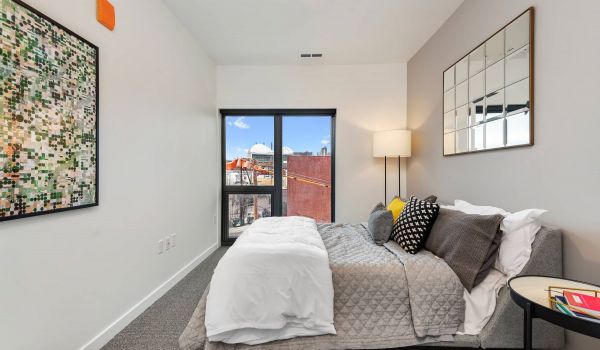 Arterra apartment interior featuring bedroom with large windows