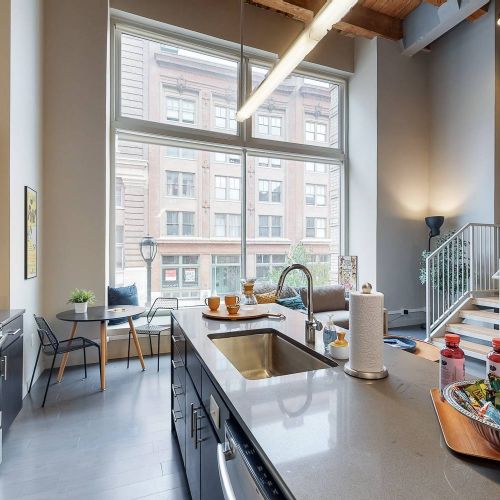 Roaster's Block apartment interior with open kitchen and high ceilings