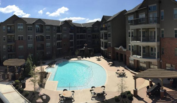 The Village at Mission Farms building exterior with pool