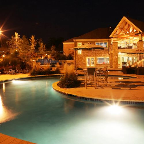 Barrewoods apartment building exterior with pool at night
