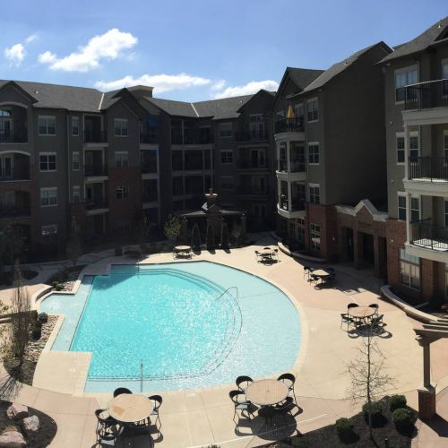 The Village at Mission Farms building exterior with pool