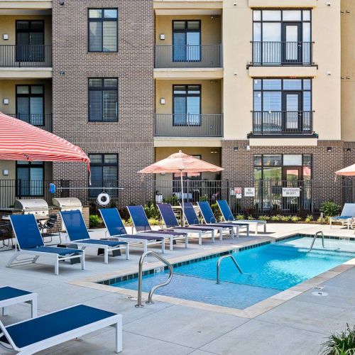 The District Flats apartment community pool and outdoor lounge