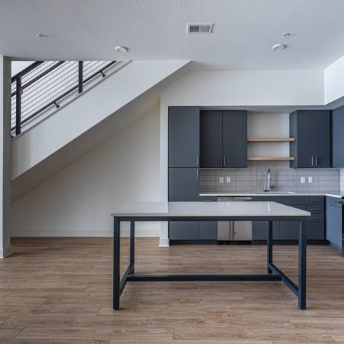 225 Sycamore apartment kitchen and living area with staircase