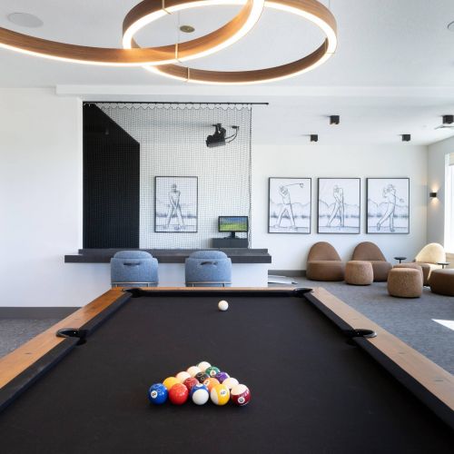 The Grandeur at Holladay Hills game room with pool table and golf simulator